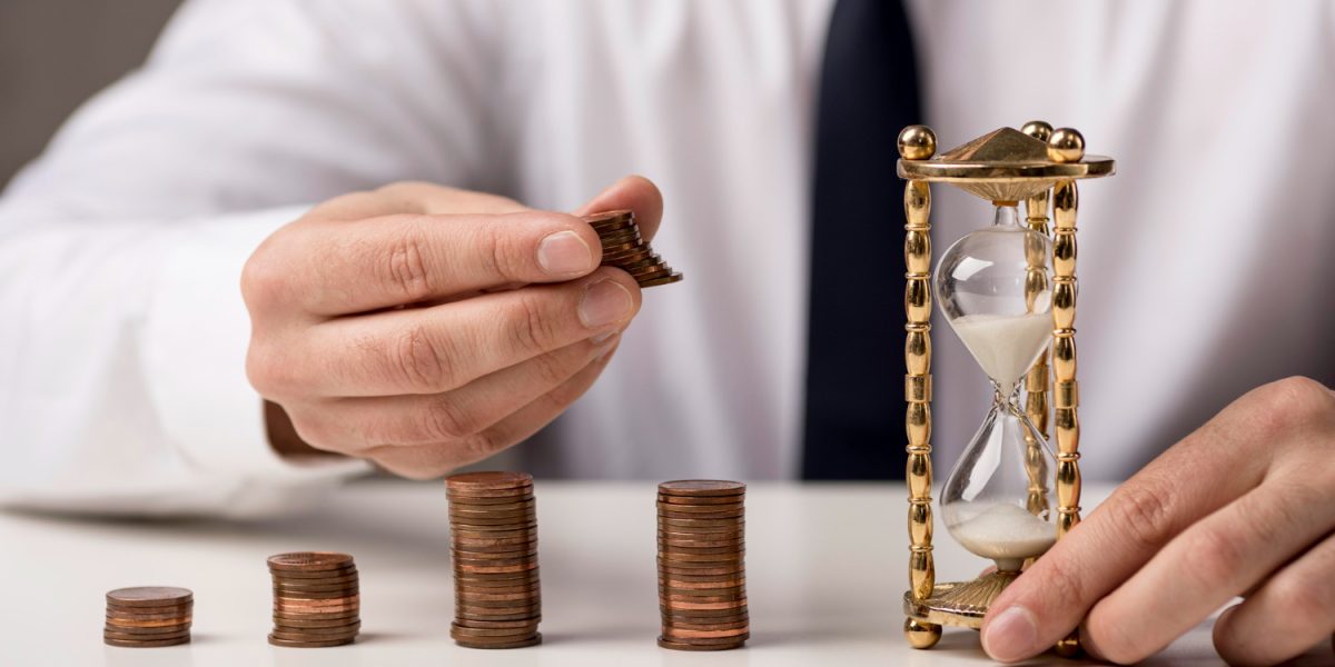 front-view-businessman-with-coins-hourglass